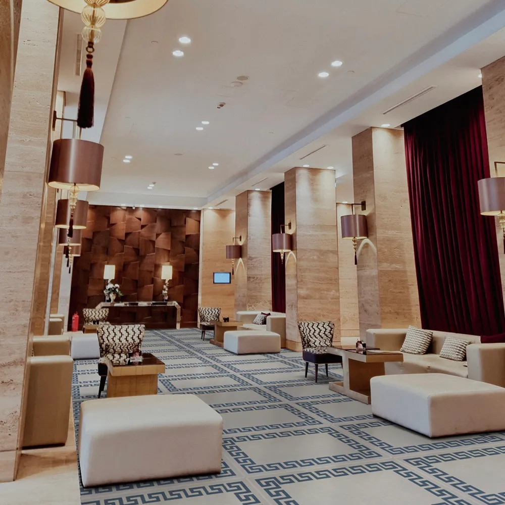 Commercial flooring visualised in a hotel lounge with patterned floor tiles