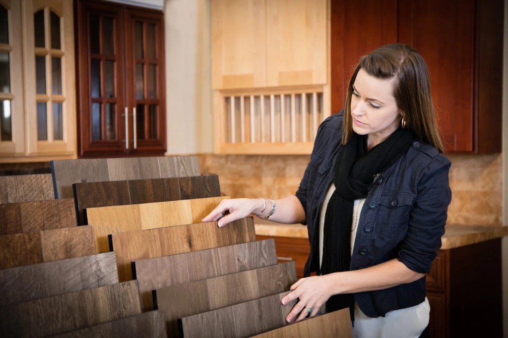 Customer choosing from flooring sample boards in a showroom